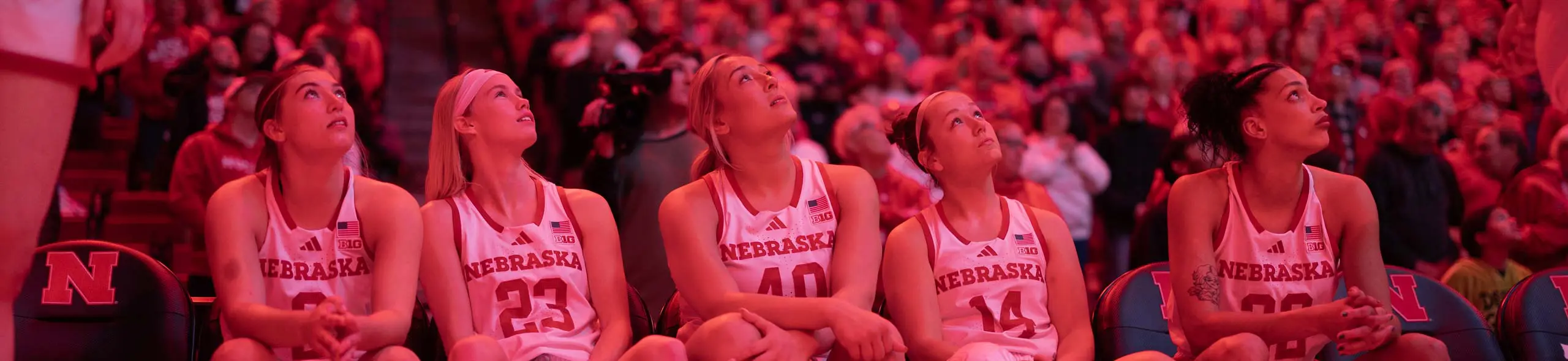 basketball players looking up on sideline