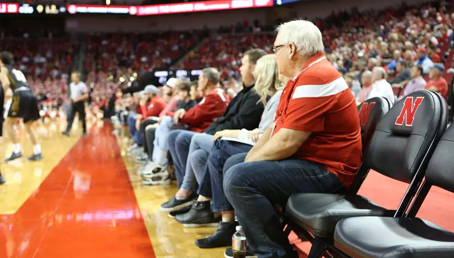 Fans watching basketball game court-side