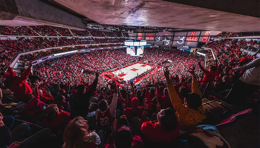 Fans watching basketball game court-side