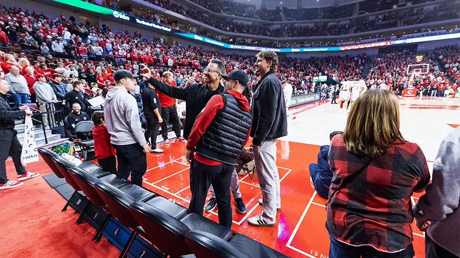 Fans on the side court taking a selfie