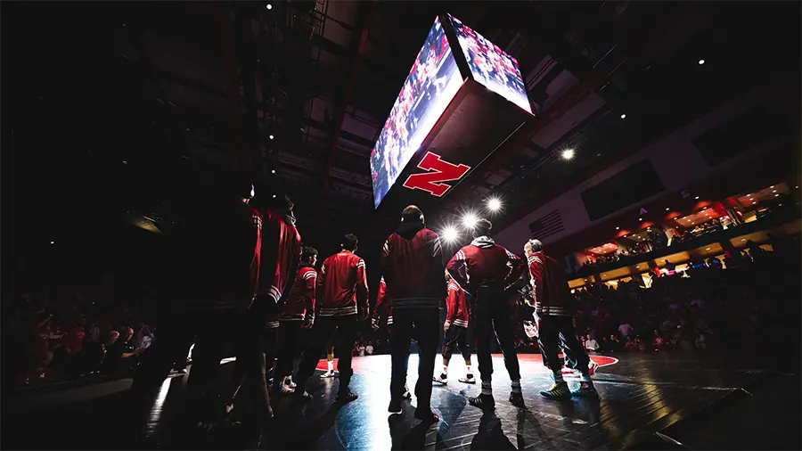 Players standing on the court with the lights low